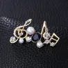 Musical notes - crystal brooch