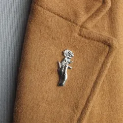 Silver brooch with a hand holding rose - pin