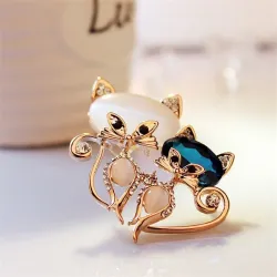 Brooch with two crystal foxes