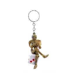 Squelette assis sur un dé - porte-clés