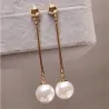 Long golden earrings with a pearlEarrings