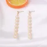 Boucles d'oreilles longues dorées élégantes - métal géométrique avec perles