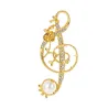 Note de musique en cristal doré avec perle - broche