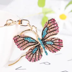 Porte-clés doré avec un papillon en cristal